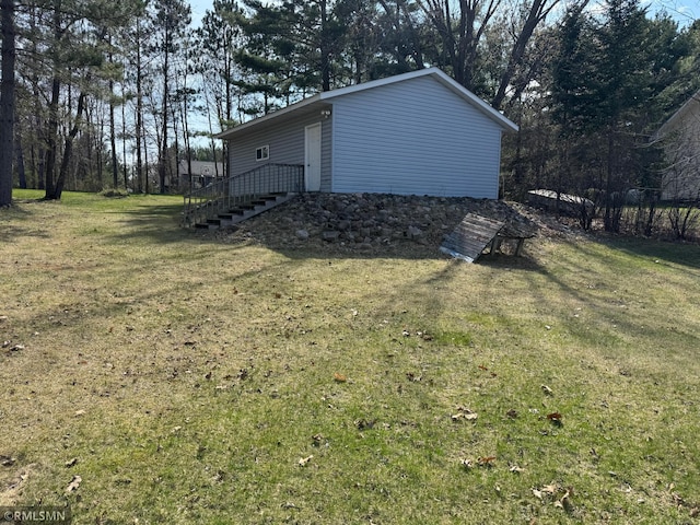 view of side of home with a lawn