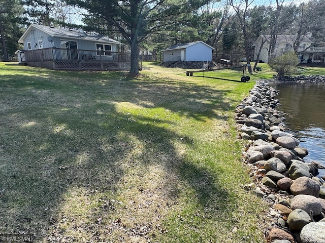 view of yard featuring a deck with water view