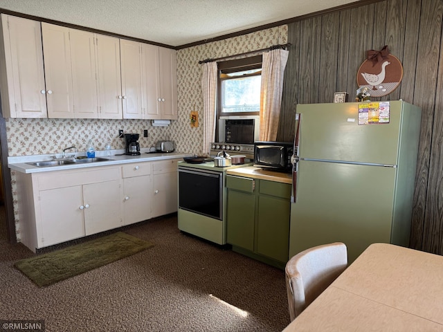 kitchen with crown molding, freestanding refrigerator, white cabinets, and electric stove