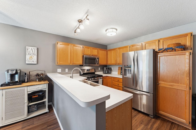 1711 121st Ln NW, Coon Rapids, MN 55448 - kitchen with stainless steel appliances, light countertops, a peninsula, dark wood-type flooring, and a textured ceiling