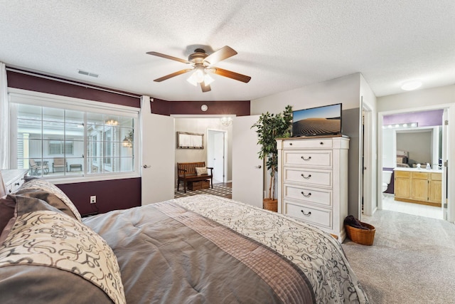 1711 121st Ln NW, Coon Rapids, MN 55448 - bedroom with a textured ceiling, carpet floors, ceiling fan, and connected bathroom