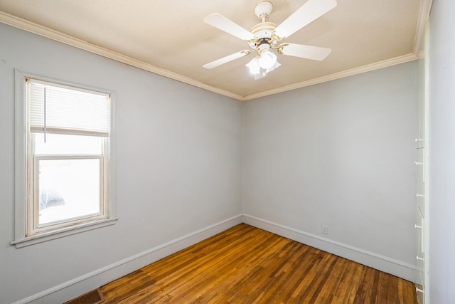 empty room with baseboards, wood finished floors, plenty of natural light, crown molding, and a ceiling fan
