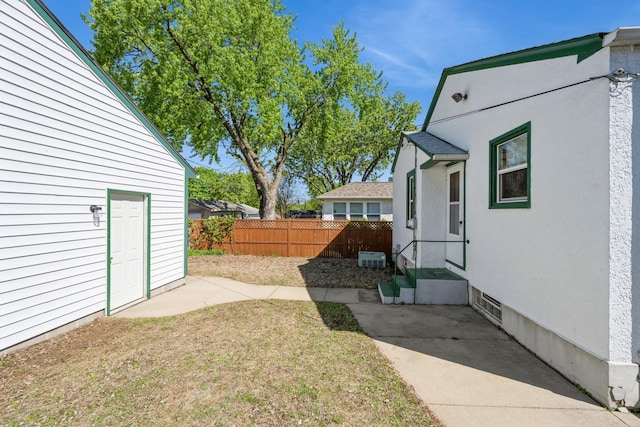 view of yard featuring fence and a patio