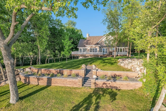 42429 Big Mcdonald Dr, Dent, MN 56528 - rear view of house with a yard, a chimney, and a wooden deck