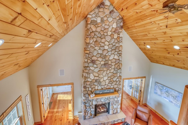 42429 Big Mcdonald Dr, Dent, MN 56528 - unfurnished living room with wood ceiling, wood finished floors, high vaulted ceiling, a fireplace, and healthy amount of natural light