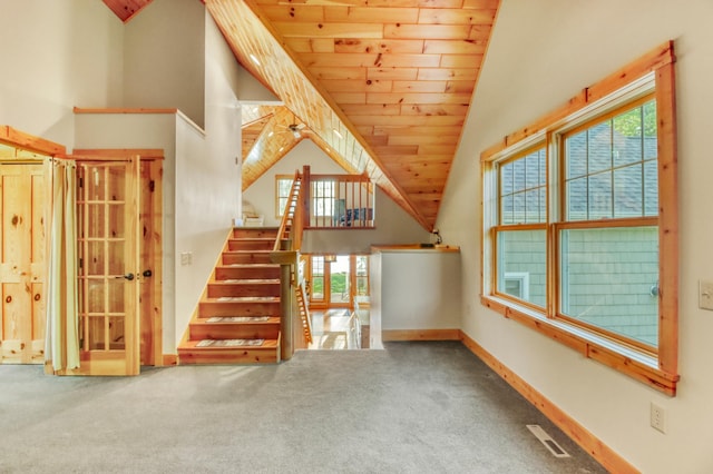 42429 Big Mcdonald Dr, Dent, MN 56528 - unfurnished living room featuring wood ceiling, carpet floors, baseboards, high vaulted ceiling, and stairs