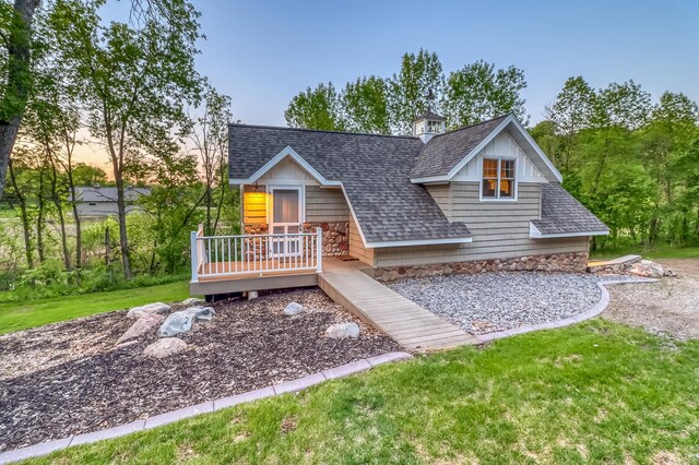 42429 Big Mcdonald Dr, Dent, MN 56528 - view of front of property with a shingled roof, a deck, and a yard