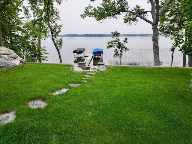 42429 Big Mcdonald Dr, Dent, MN 56528 - view of green lawn with a water view, a boat dock, and boat lift