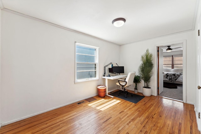 office with baseboards, a ceiling fan, wood finished floors, and a wealth of natural light