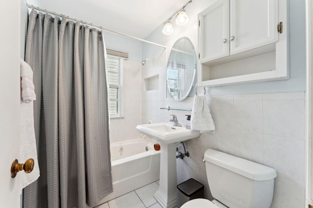 full bath with tile walls, tile patterned flooring, toilet, and shower / bath combination with curtain