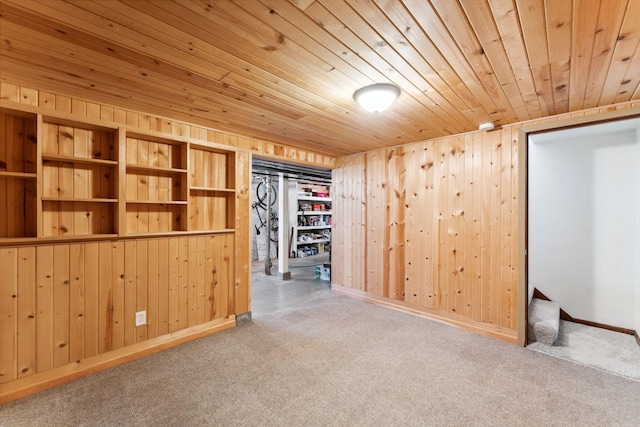 interior space with wooden walls, stairs, carpet floors, and wood ceiling