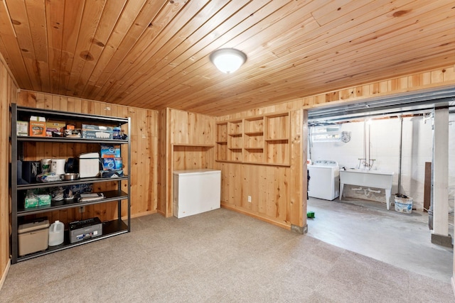 below grade area featuring washer / dryer, wooden ceiling, refrigerator, and wooden walls