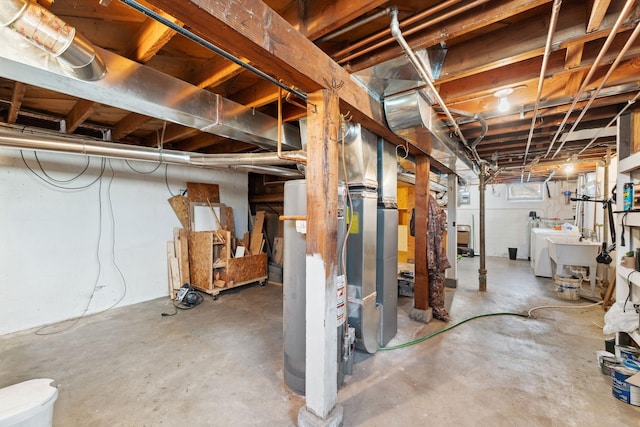 unfinished below grade area with a sink and gas water heater