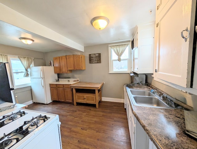 kitchen featuring white appliances, baseboards, dark wood-style floors, and a healthy amount of sunlight