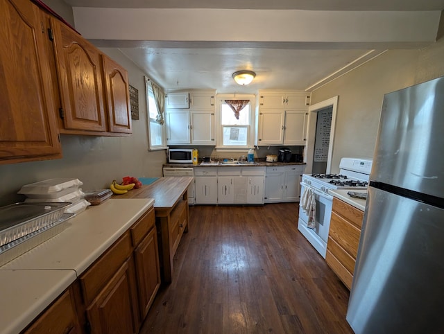kitchen featuring dark wood-style flooring, white appliances, white cabinetry, brown cabinets, and a sink