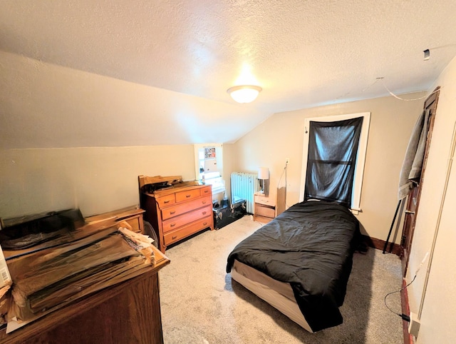 bedroom featuring radiator heating unit, light carpet, a textured ceiling, and lofted ceiling
