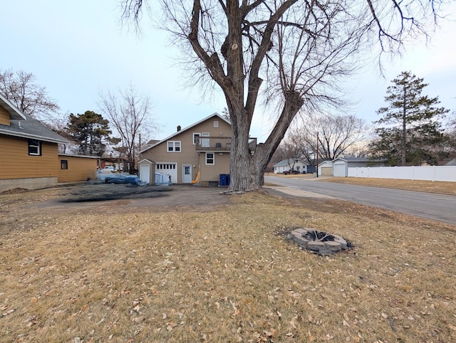 view of yard featuring a garage and fence