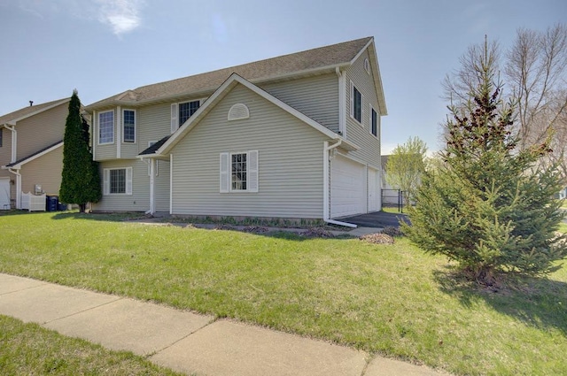 view of front of home with a garage and a front lawn