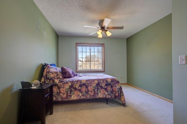 bedroom with baseboards, a textured ceiling, light carpet, and ceiling fan