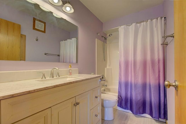 bathroom featuring toilet, shower / tub combo with curtain, and vanity