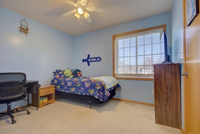 carpeted bedroom featuring baseboards, ceiling fan, and visible vents