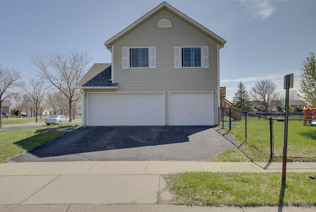 view of front facade with a garage, a front lawn, aphalt driveway, and fence