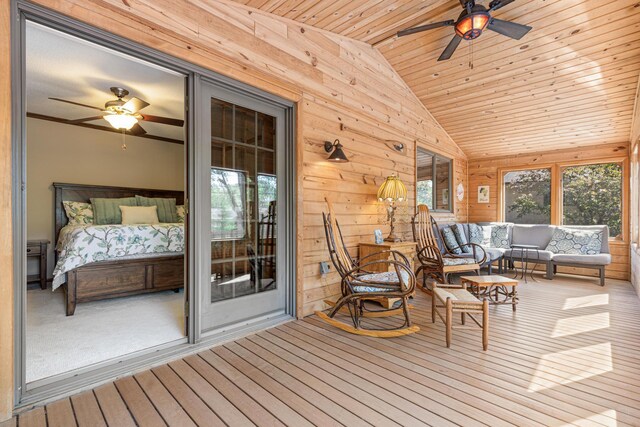 sunroom with ceiling fan, outdoor lounge area, and vaulted ceiling