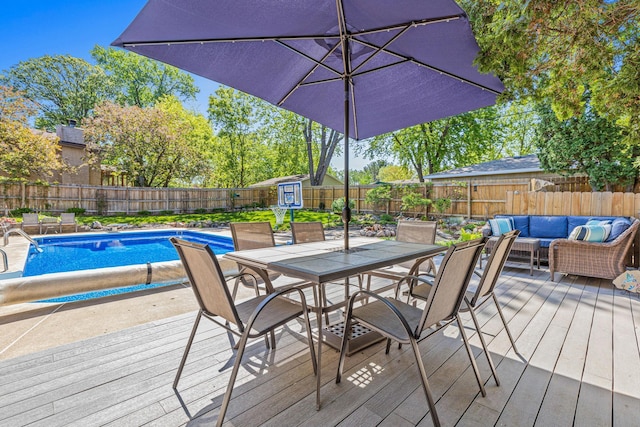 view of pool featuring a deck, outdoor dining area, a fenced backyard, and an outdoor hangout area