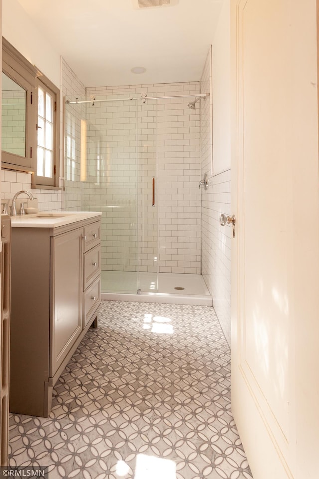 full bath with a shower stall and vanity