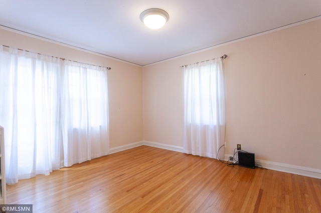 empty room with light wood-style floors and baseboards