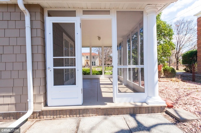 doorway to property featuring fence