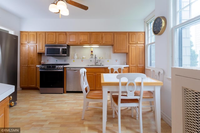 5128 Irving Ave S, Minneapolis, MN 55419 - kitchen featuring stainless steel appliances, a sink, backsplash, light countertops, and ceiling fan
