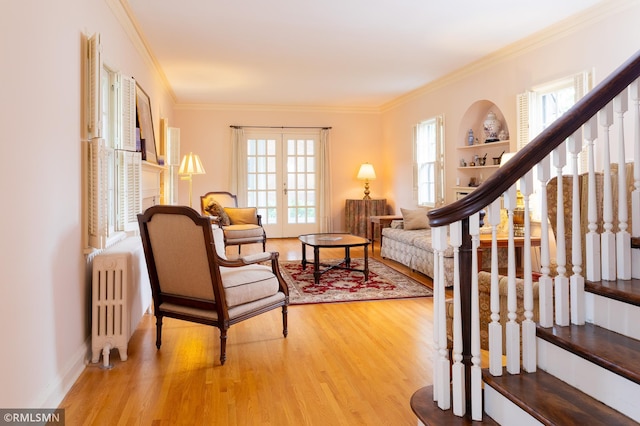 5128 Irving Ave S, Minneapolis, MN 55419 - living area featuring radiator heating unit, wood finished floors, stairs, and crown molding