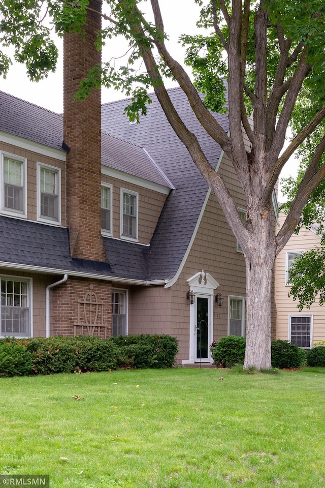 5128 Irving Ave S, Minneapolis, MN 55419 - shingle-style home featuring roof with shingles, a front lawn, and a chimney