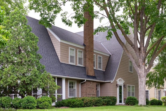 5128 Irving Ave S, Minneapolis, MN 55419 - view of front facade featuring roof with shingles, a chimney, a front lawn, and a gambrel roof