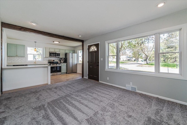 140 Carol Ln, West Saint Paul, MN 55118 - unfurnished living room featuring light colored carpet, visible vents, baseboards, and a sink