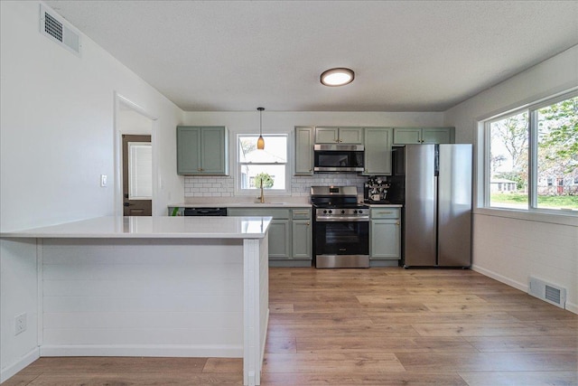 140 Carol Ln, West Saint Paul, MN 55118 - kitchen featuring light wood-type flooring, stainless steel appliances, and visible vents