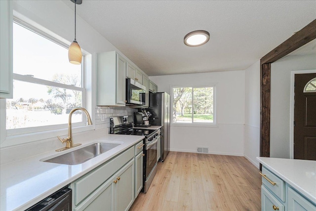 140 Carol Ln, West Saint Paul, MN 55118 - kitchen featuring light countertops, stainless steel appliances, and a sink