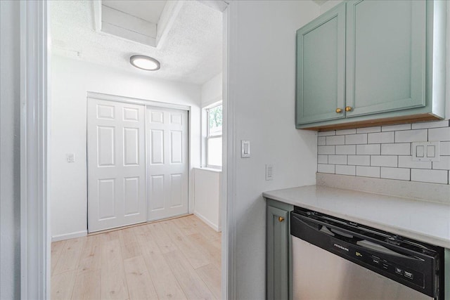 140 Carol Ln, West Saint Paul, MN 55118 - kitchen featuring tasteful backsplash, light wood-type flooring, dishwasher, light countertops, and green cabinets