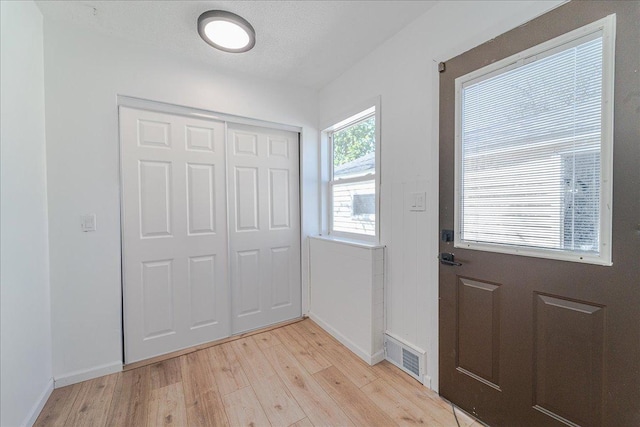 140 Carol Ln, West Saint Paul, MN 55118 - entryway featuring light wood finished floors, visible vents, and baseboards