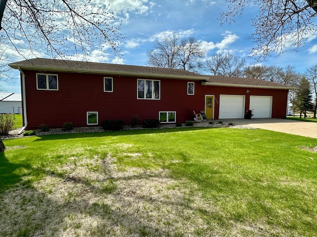 view of front of property featuring driveway, a front yard, and a garage
