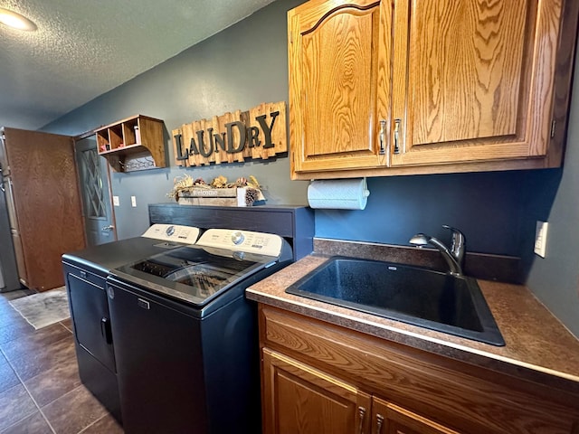 kitchen featuring independent washer and dryer, a textured ceiling, a sink, and open shelves