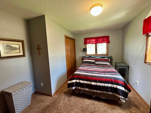 bedroom with carpet flooring, a textured ceiling, and a closet