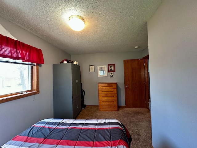 bedroom with carpet floors and a textured ceiling