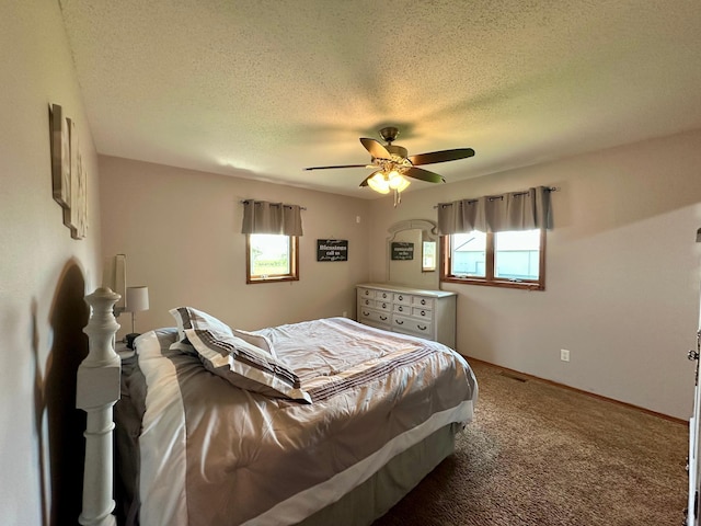 bedroom with a ceiling fan, a textured ceiling, baseboards, and carpet