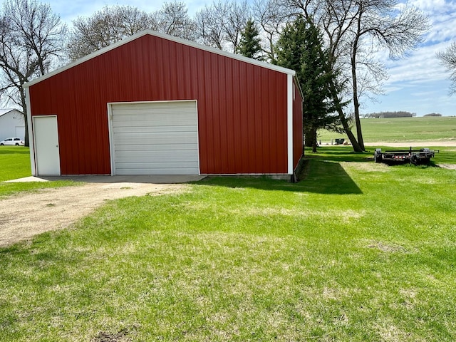 detached garage featuring dirt driveway
