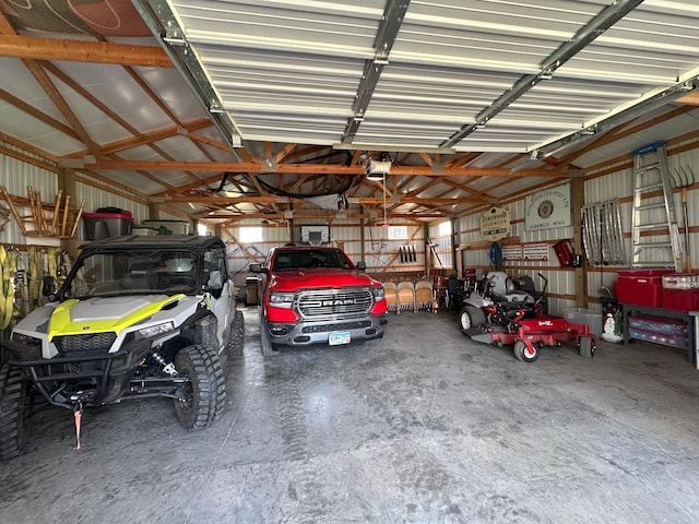 garage with metal wall and a garage door opener