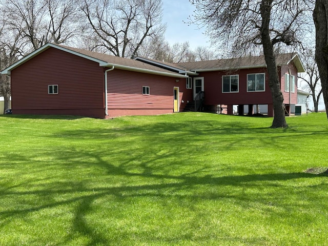 back of house featuring a yard