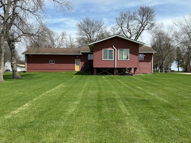 back of property with a lawn