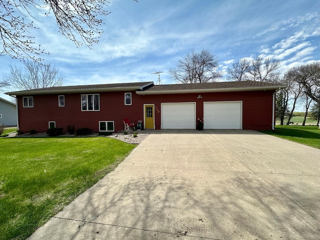 view of front of house with driveway, a front yard, and a garage